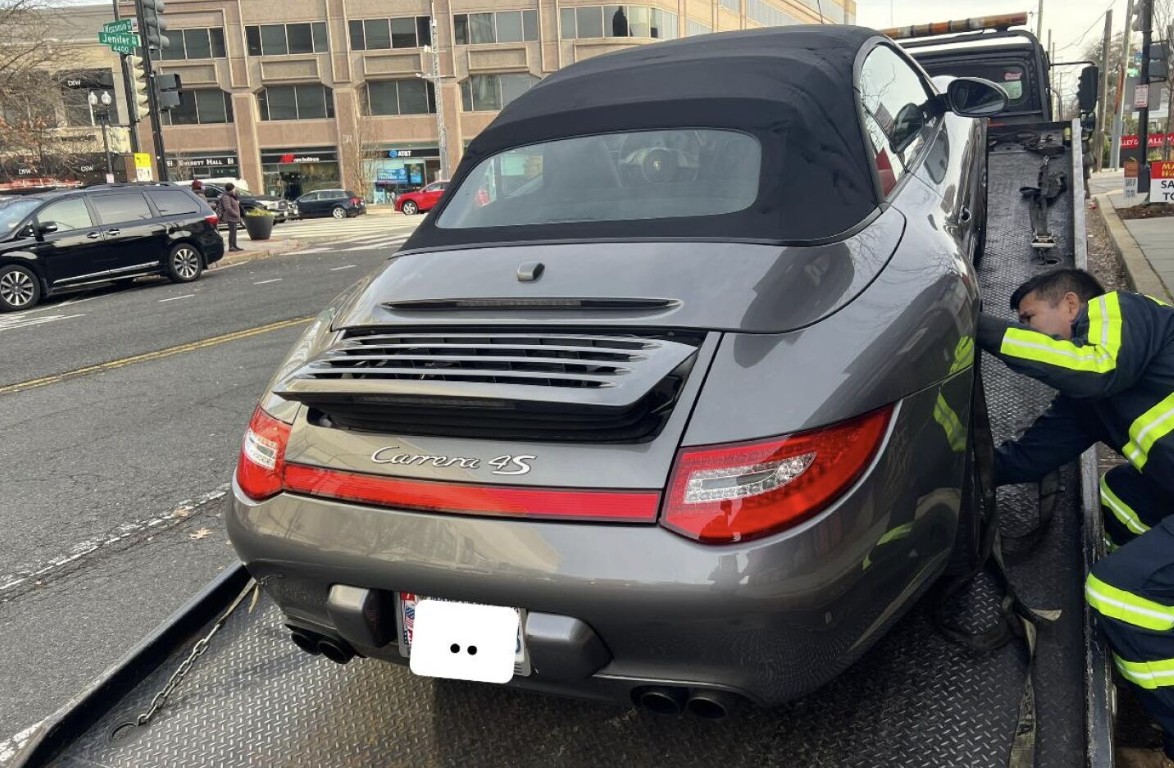 Porsche 911 loaded on a flatbed tow truck for long distance towing service in Cardiff, CA