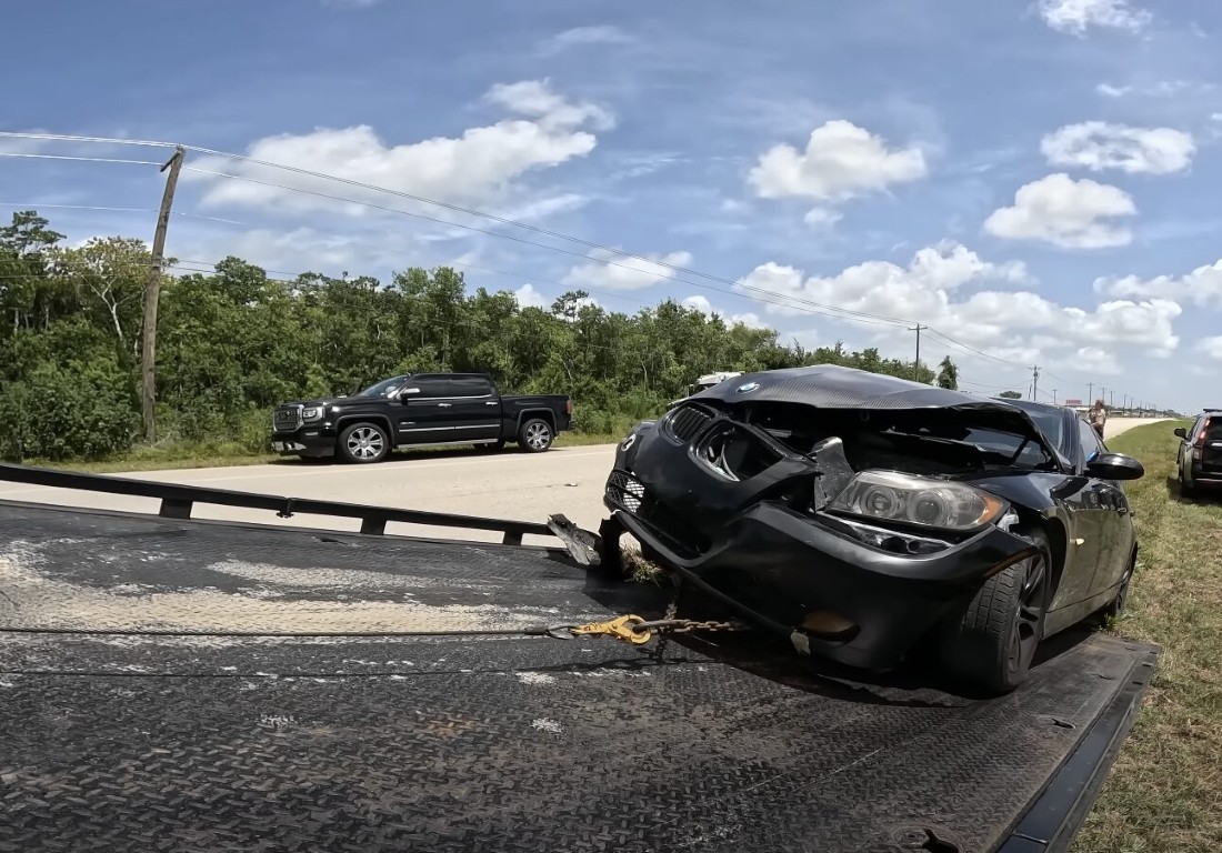 Wrecked vehicle being carefully loaded onto a flatbed after an accident in Solana Beach, CA